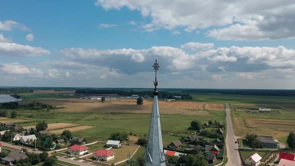 Drone Flies Around Gothic Church Amid Picturesque Countryside in Belarus