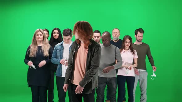 Cowd of People of Different Races and Ages Stands on a Green Background Young Guy Sneezes Other alt