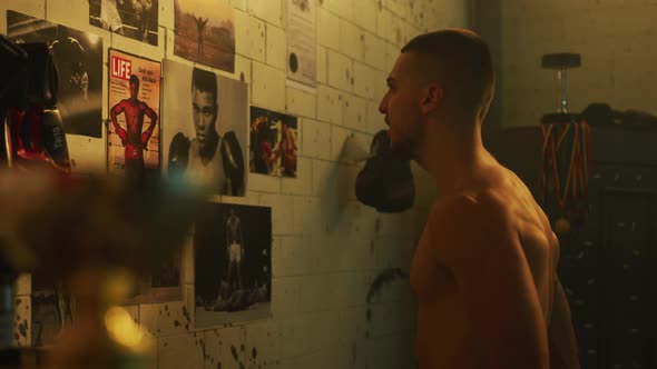 Man training while looking at professional boxers pictures alt