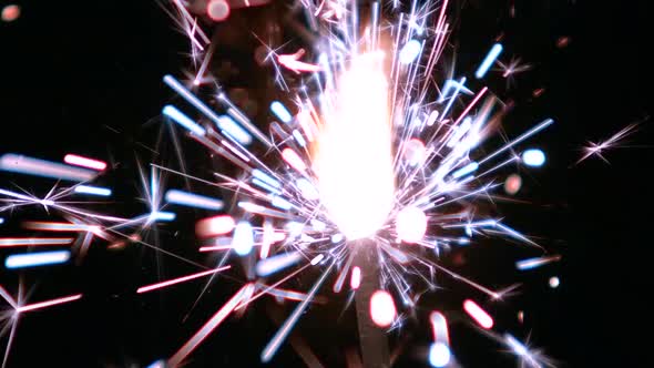 Bengal Light Burns with Sparks, Black Background, Close Up, Slow Motion alt