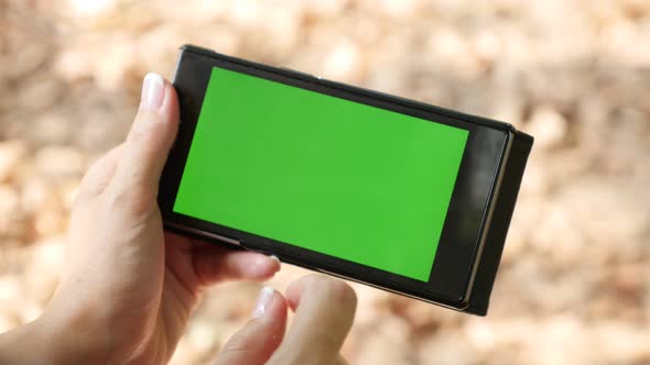 Woman using green screen smart phone display in nature  4K 2160p 30fps UltraHD video - Female using 