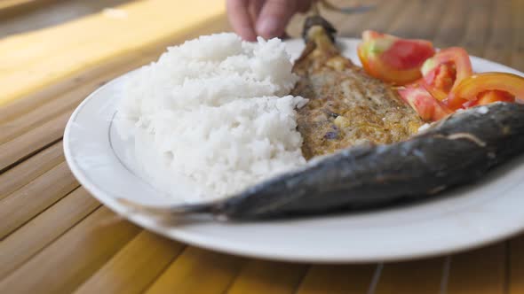 A Plate of Filipino Food Fried Eggplant Fish Fresh Tomatoes with White Rice