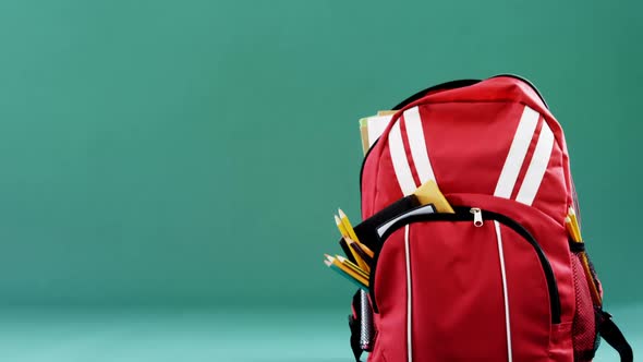 Schoolbag on green background alt