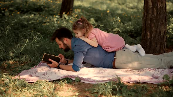 Daddy Watching Fairy Tale Story On Mobile Phone Screen. Dad Teach Preschool Child Girl. alt