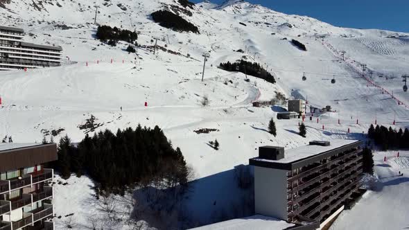 Majestic Winter Aerial Landscape and Ski Resort with Typical Alpine Wooden Houses in French Alps