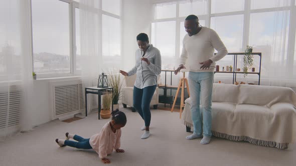 Afro American Little Girl African Preschooler Trying to Push Up Shows Parents Sports Exercise Ethnic alt