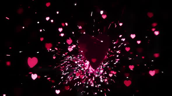 Pink heart confetti and sparks flying against heart