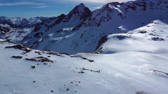 Mountain ravine covered in snow and ice during winter from a drone point of view alt