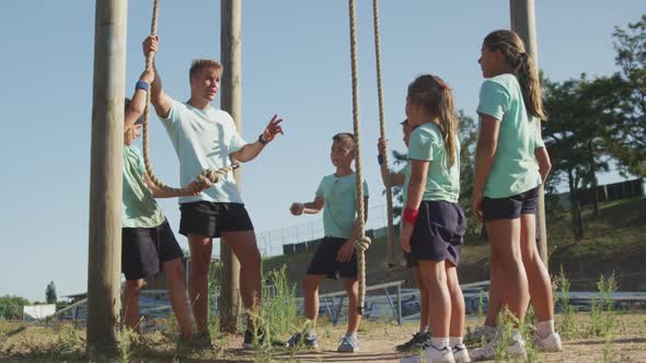 Group of Caucasian children training at boot camp alt