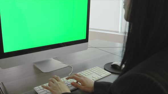 Woman In Office Using Computer Green Screen 1