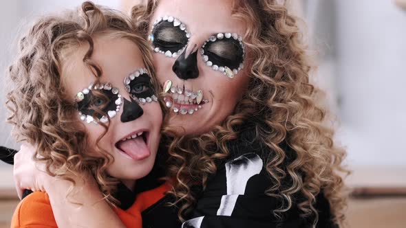 Portrait of Mother and Daughter with Curly Hair Wearing Costumes alt