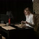 a Lonely Woman Sits on a Sofa in a Restaurant Cutting Food and Eating - VideoHive Item for Sale