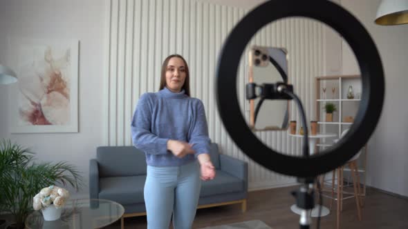 Teenager girl dancing at home when making video for social media.