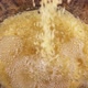 Rice is poured into a glass bowl with water. Slow motion. - VideoHive Item for Sale