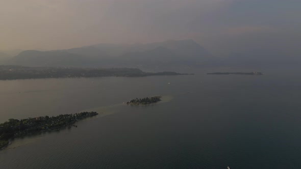 Aerial view of Bay of Manerba and San Biagio Island on lake Garda at sunrise. alt