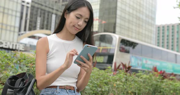 Woman use of smart phone in city alt