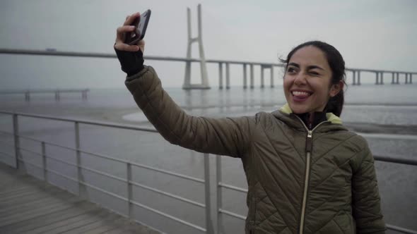 Happy Hindu Woman Posing and Gesturing for Selfie. alt