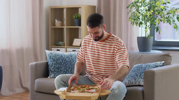 Man Opening Box and Eating Takeaway Pizza alt