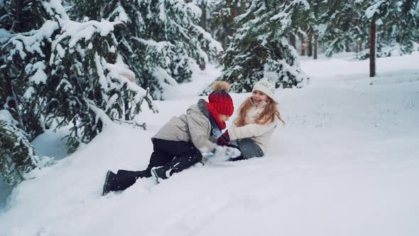 smiling children playing on snow in winter holiday alt