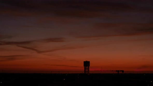 Sunset To Night - Silhouette Of Water Tank At Golden Hour In Sunset. - timelapse alt