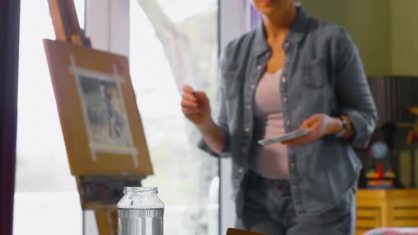 Female painter painting on a canvas at home 4k