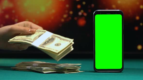 Woman Putting Bundles of Dollars on Desk, Online Betting App, Big Winnings alt