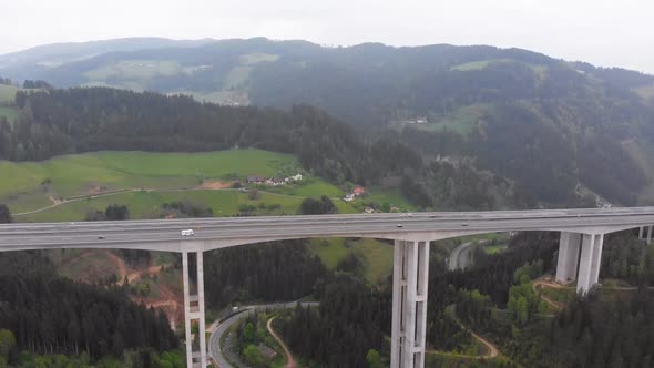 Aerial View of the Highway Viaduct on Concrete Pillars in the Mountains alt