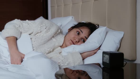 Beautiful Girl Sleeping in Bed at Home Wakes Up To Turn Off the Alarm and Dodges Sleep alt