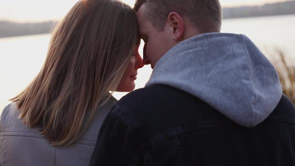 Portrait of Romantic Couple Relaxing in Caresses at Lake alt