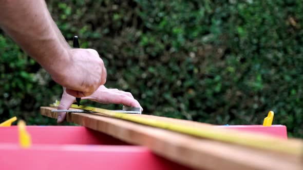 Taking Measurements in Slow Motion, Carpenter Prepares Wood for New Project, Daytime Outdoors alt