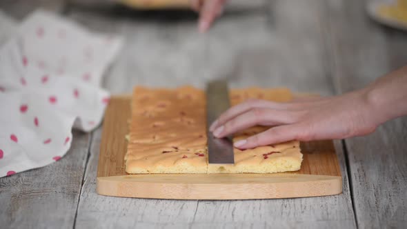 Pastry Chef Cutting Sponge Cake Layers with Kitchen Knife