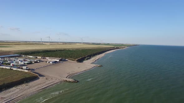 Aerial View of Summer Countryside with Wind Turbines. Aerial Shot alt