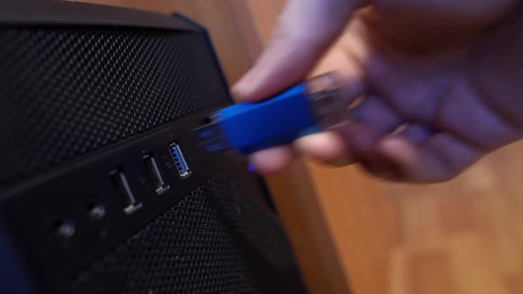 An Office Worker Inserts And Pulls Out A Usb Flash Drive Into The Usb Connector Of A Computer
