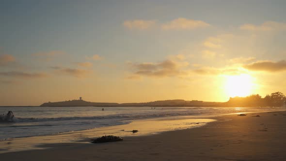 Pillar Point from El Granada, California and Cloudy Sky with a Beatiful Sunset and Surfers Riding th alt