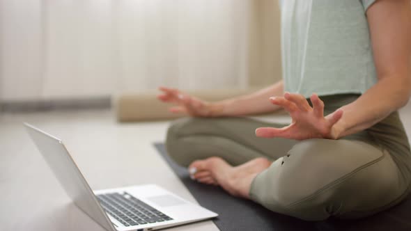 Unrecognizable Woman Teaching Yoga Class via Video Call alt