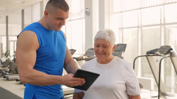 An Elderly Woman is Photographed on a Tablet Video Call Rest After Training Sends Greetings to alt