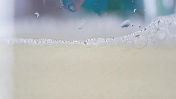 Champagne Pouring and Foaming in Glasses
