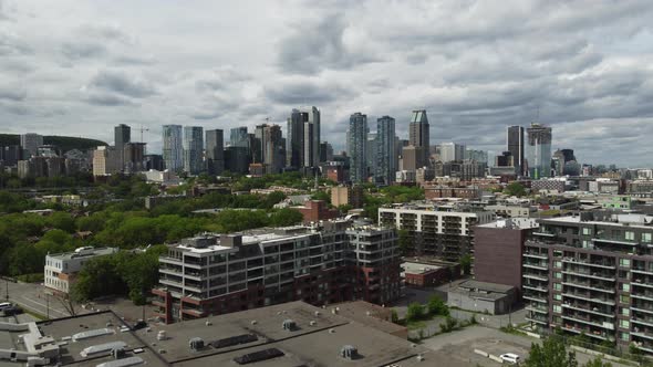 Aerial view by drone of condominium, residential area close to downtown Montreal, approaching skyscr alt