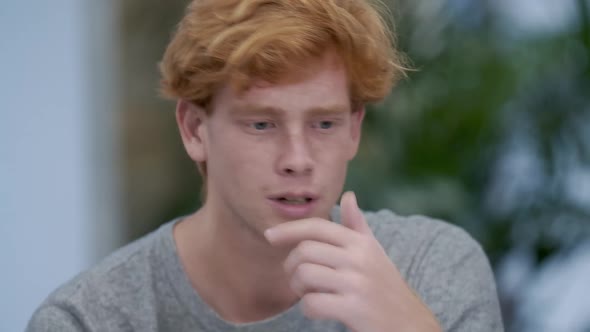 Young Millennial Handsome Redhead Man Talking and Thinking. Close-up Portrait of Confident Caucasian alt