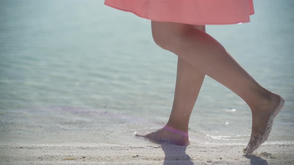 Image of female feet walking on the beach