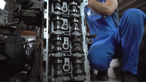 View of disassembled car engine. hands of mechanic repairing engine alt