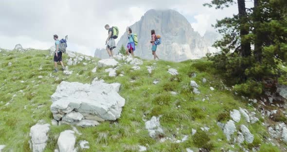 Aerial Flight Above People Hiking Along Trail Path in Sunny Day alt