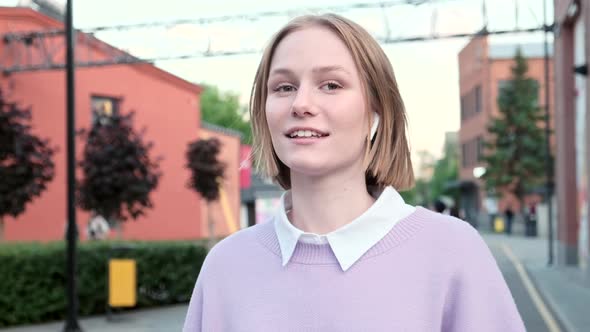 Young Woman with Short Fair Hair and Wireless Headphones alt