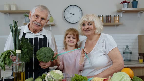 Grandchild Girl with Senior Grandparents Recommending Eating Raw Vegetable Food. Nutrition Diet alt
