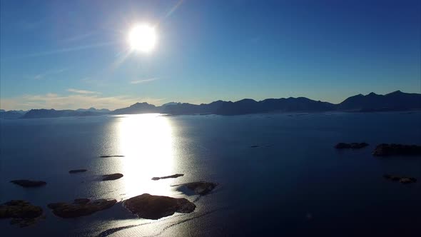 Lofoten islands, Norway, aerial footage against the sun