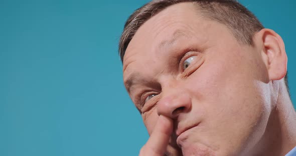 Mature Actor Picks Nose with Finger Pulling Funny Face Close alt