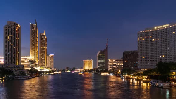 Bangkok city center and Chao Phraya River during twilight, day to night, zoom in - time lapse