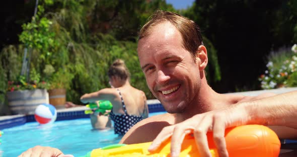 Portrait of man smiling near swimming pool alt