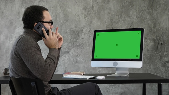 Male Designer Working At Computer In Contemporary Office. alt