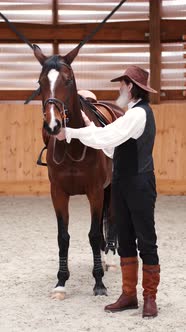 A Closeup of Senior Couple Petting a Horse in a Stable alt